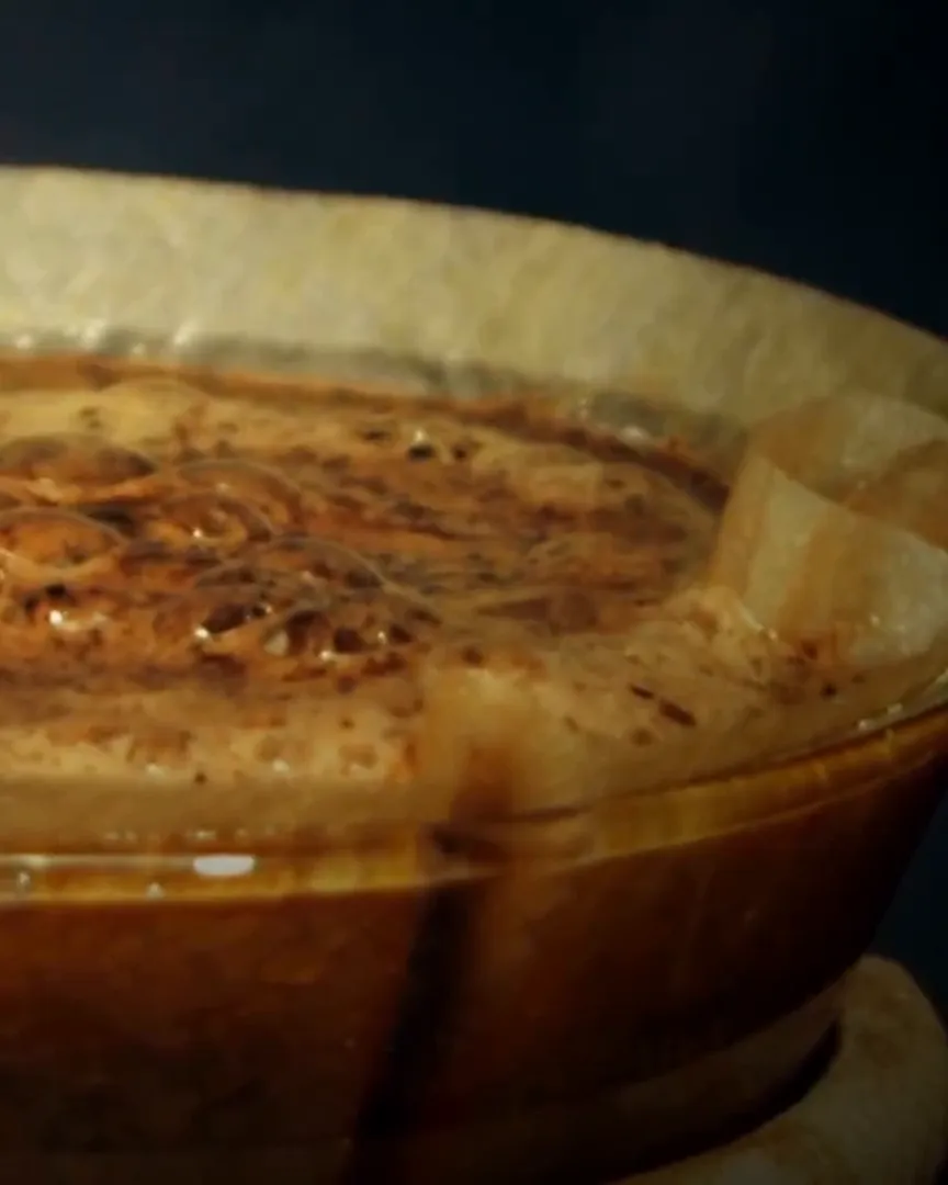Hot water blooming fresh coffee grounds in a paper filter